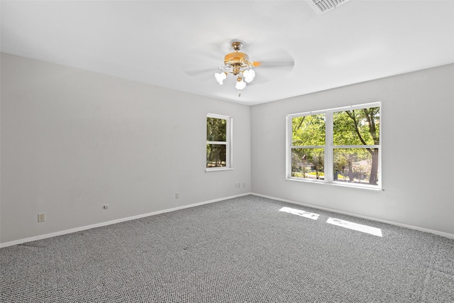 carpeted spare room with ceiling fan