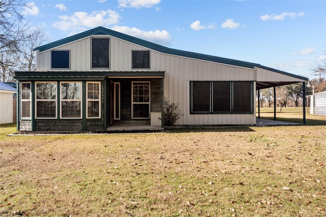 back of property with a lawn