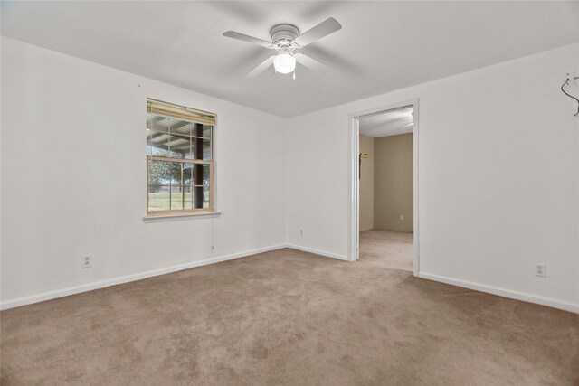 carpeted spare room with ceiling fan