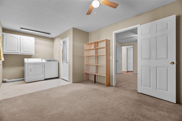 laundry room featuring ceiling fan, cabinets, washer and clothes dryer, and light carpet