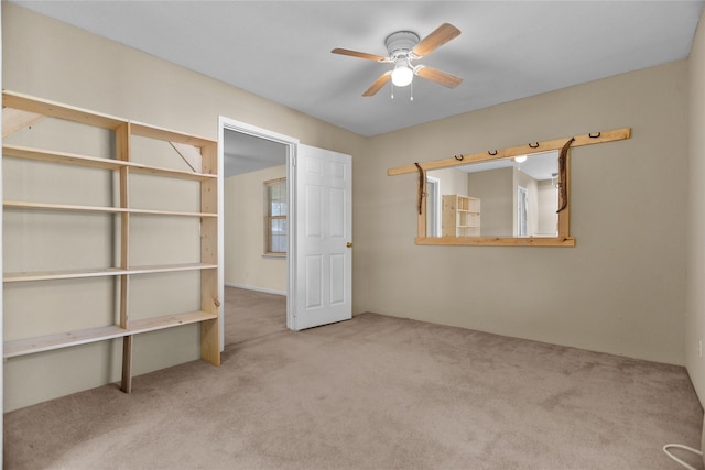 unfurnished bedroom featuring ceiling fan and light carpet