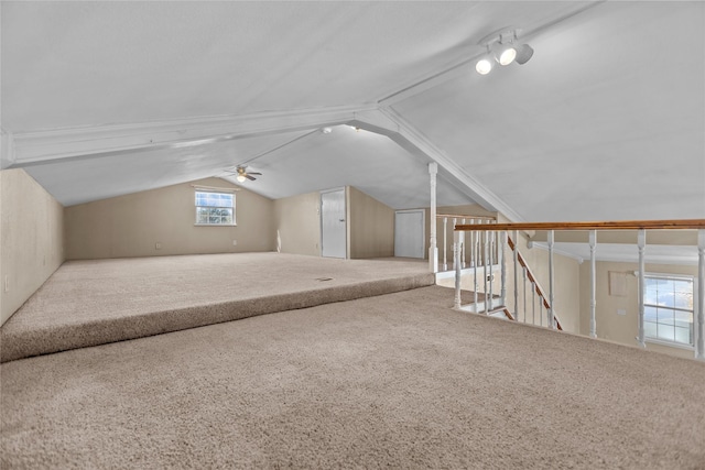 additional living space featuring ceiling fan, carpet floors, and lofted ceiling