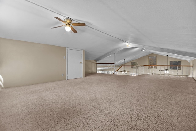 bonus room with ceiling fan, lofted ceiling, and carpet flooring