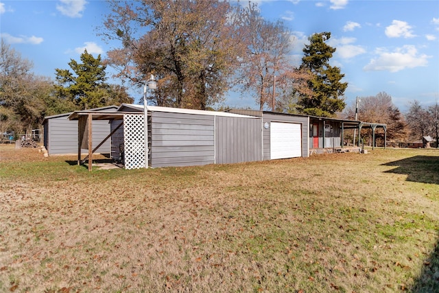 view of outdoor structure featuring a lawn and a garage