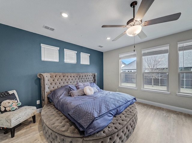 bedroom featuring ceiling fan and light hardwood / wood-style flooring