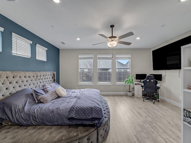 bedroom with ceiling fan and light wood-type flooring