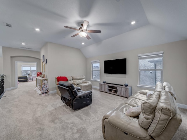 carpeted living room with ceiling fan, a healthy amount of sunlight, and lofted ceiling