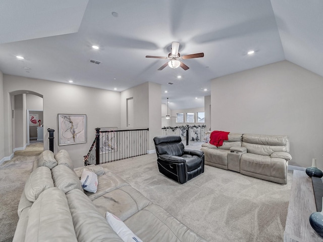 carpeted living room with ceiling fan and lofted ceiling