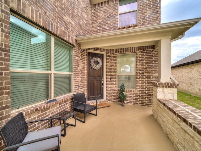 entrance to property featuring a patio area