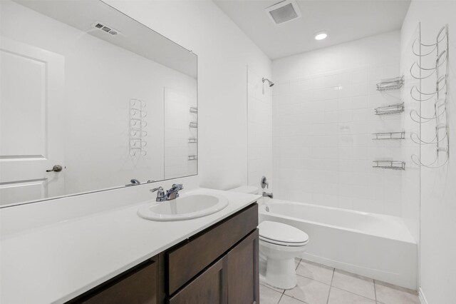 full bathroom with toilet, vanity, tile patterned floors, and tiled shower / bath