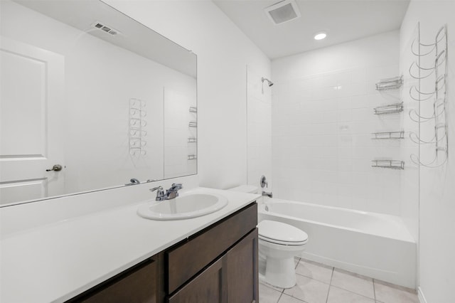 full bathroom featuring vanity, tiled shower / bath combo, tile patterned floors, and toilet