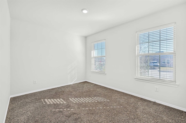 spare room featuring carpet flooring and plenty of natural light