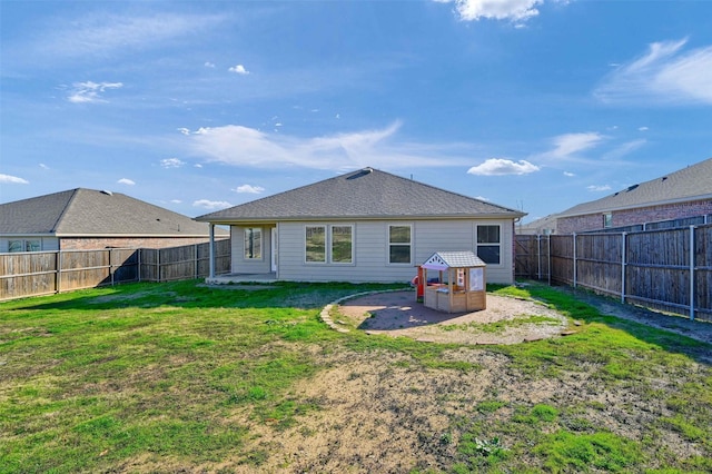 back of house featuring a yard and a patio