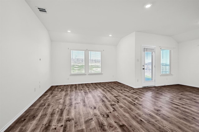 empty room featuring dark hardwood / wood-style floors and lofted ceiling