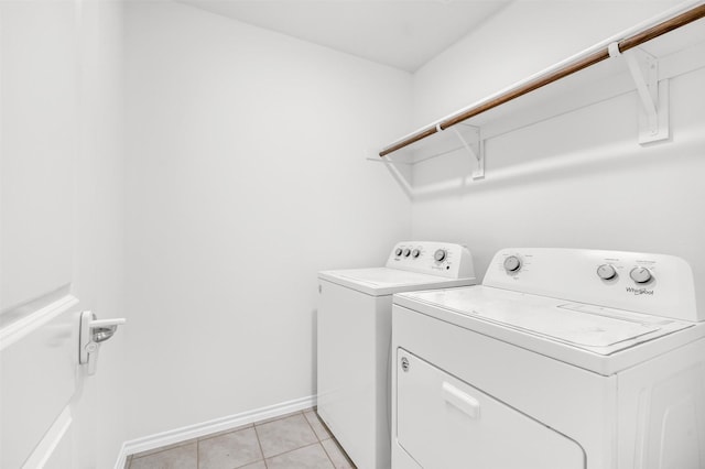 washroom featuring light tile patterned flooring and washing machine and dryer