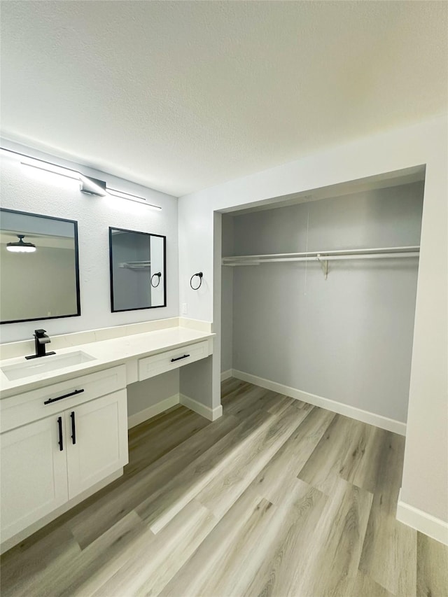 bathroom featuring vanity, hardwood / wood-style floors, and a textured ceiling