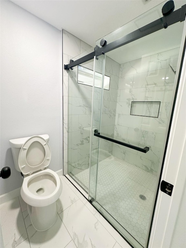 bathroom featuring toilet and an enclosed shower