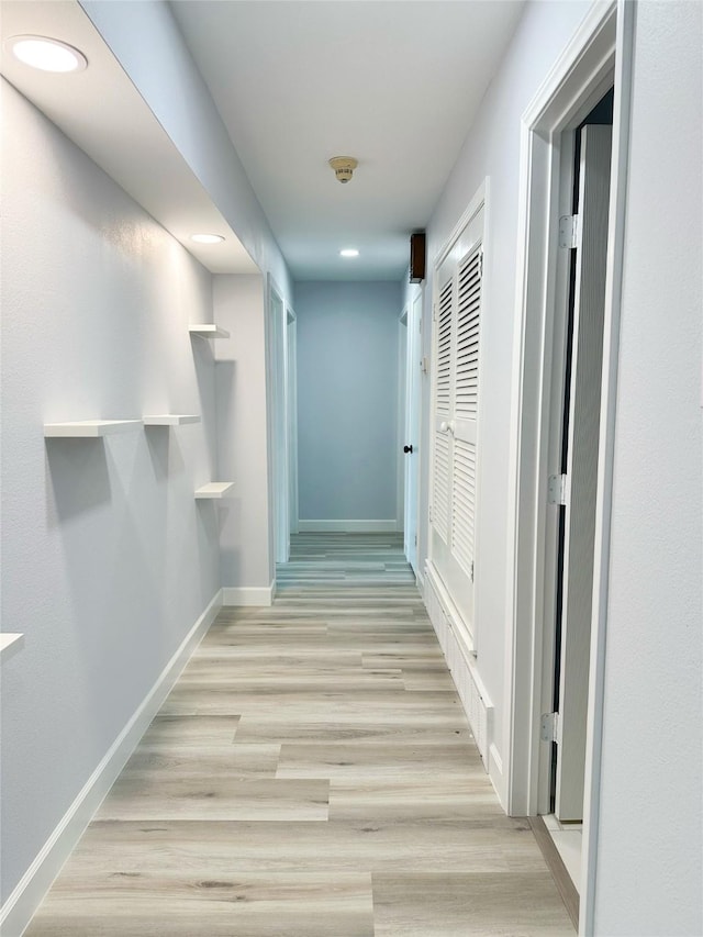 corridor with light wood-type flooring