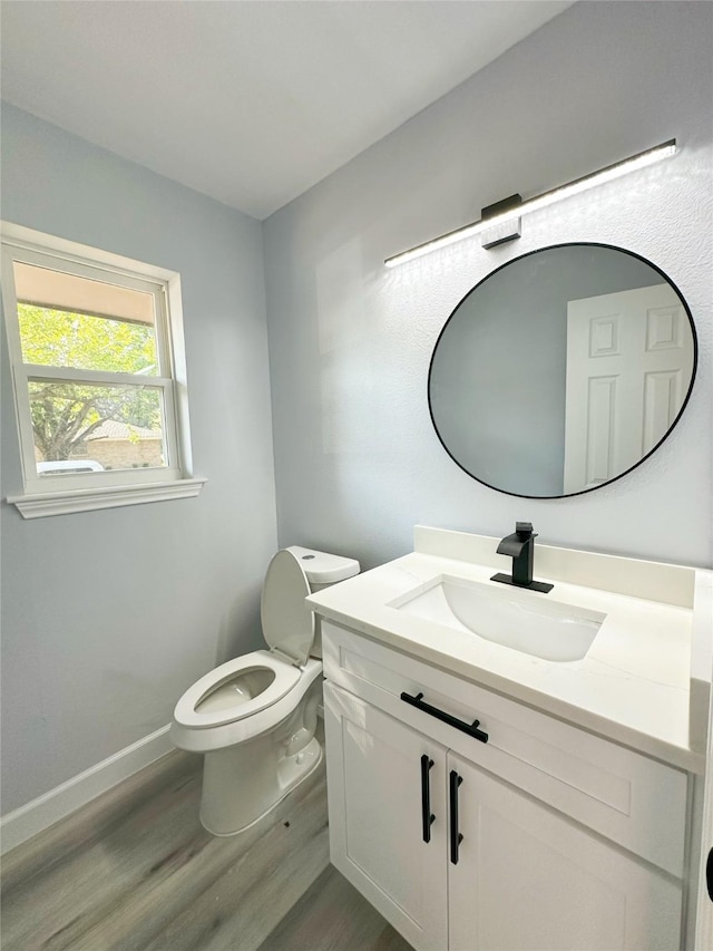 bathroom featuring hardwood / wood-style flooring, vanity, and toilet