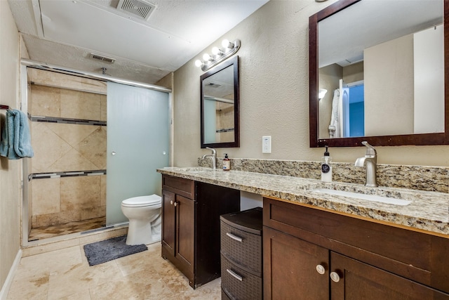 bathroom with an enclosed shower, vanity, and toilet