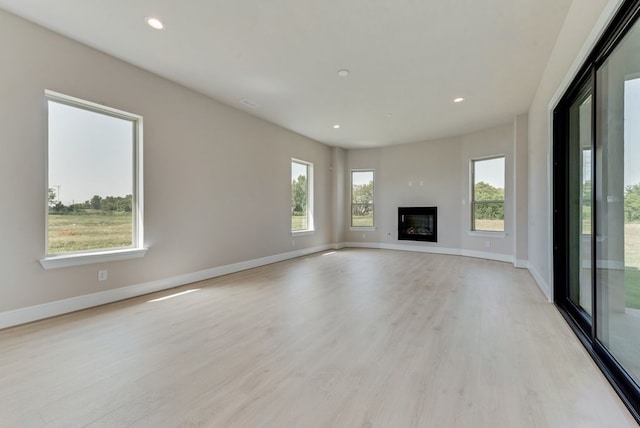 unfurnished living room with light hardwood / wood-style flooring