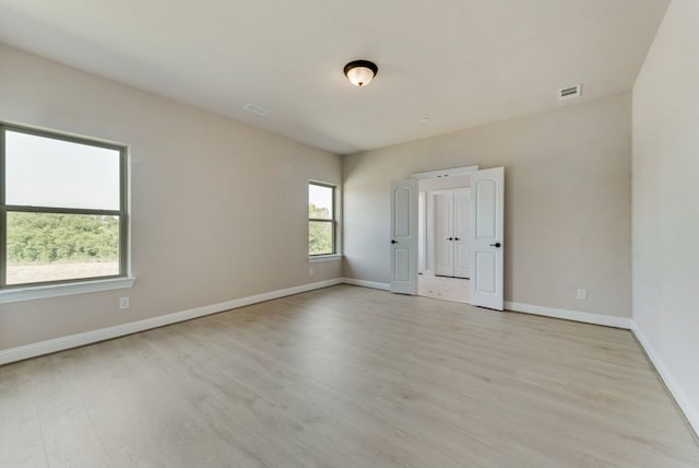 unfurnished room with light hardwood / wood-style flooring