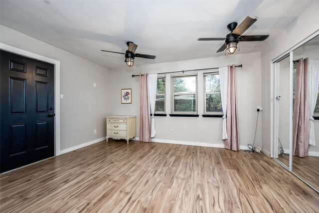 unfurnished bedroom with light hardwood / wood-style flooring and ceiling fan