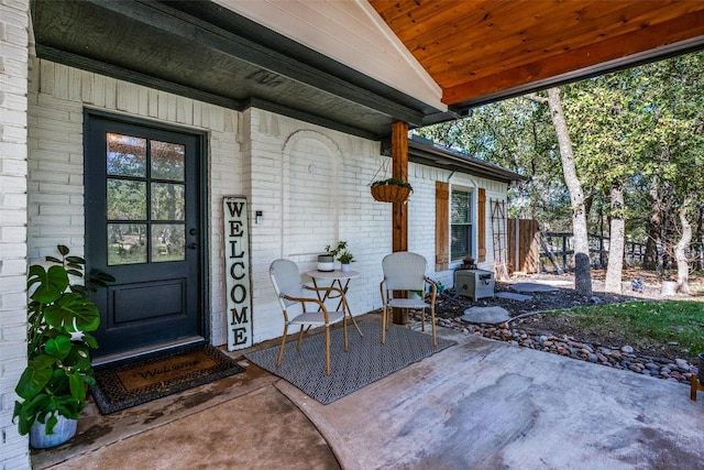 view of exterior entry featuring a patio area