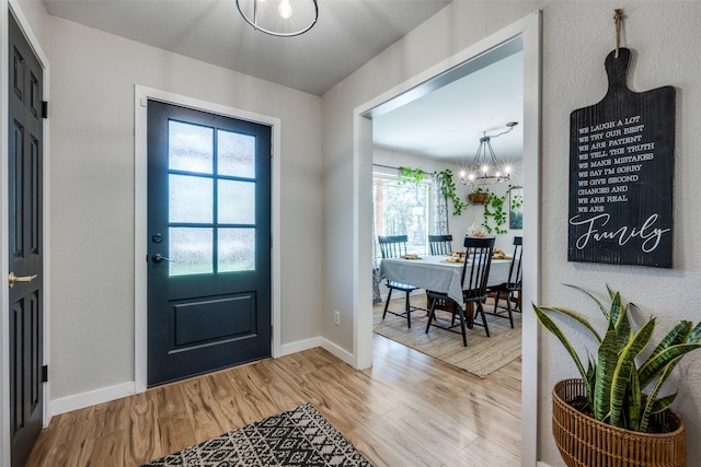 entrance foyer featuring hardwood / wood-style flooring and an inviting chandelier