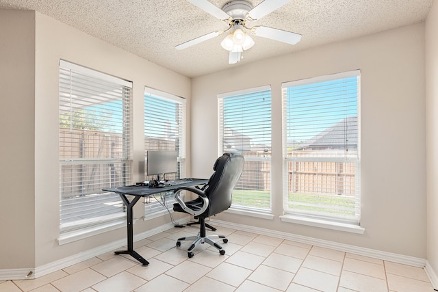 home office featuring ceiling fan, light tile patterned floors, and a textured ceiling