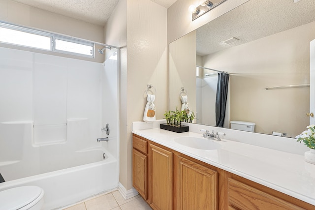 full bathroom featuring tile patterned floors, vanity, toilet, and a textured ceiling