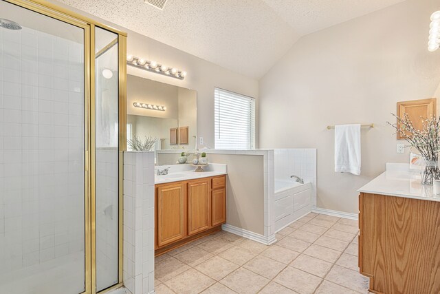 bathroom featuring a textured ceiling, vanity, vaulted ceiling, tile patterned flooring, and shower with separate bathtub