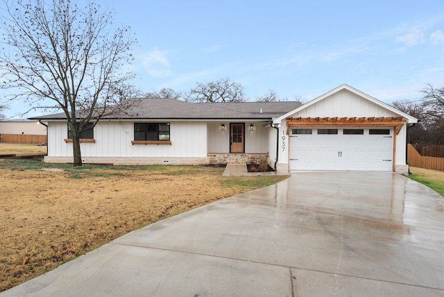 ranch-style house with a garage and a front lawn