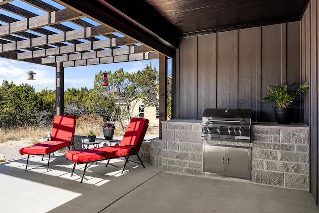 view of patio with an outdoor kitchen, grilling area, and a pergola