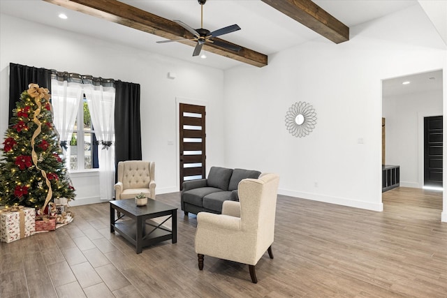 living room with ceiling fan, hardwood / wood-style floors, and beam ceiling