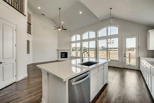 kitchen with sink, dishwasher, a kitchen island with sink, and white cabinets