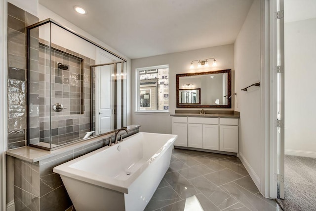 bathroom featuring vanity and independent shower and bath