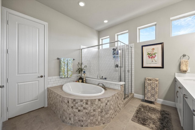 bathroom featuring shower with separate bathtub, vanity, tile patterned floors, and plenty of natural light