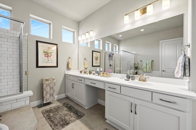 bathroom featuring tile patterned flooring, vanity, and a shower with door