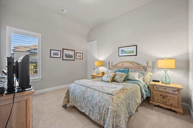 carpeted bedroom with lofted ceiling