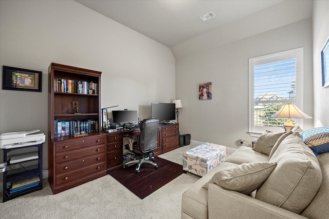 carpeted office with vaulted ceiling