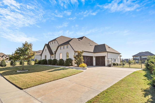 view of front of house featuring a garage and a front lawn