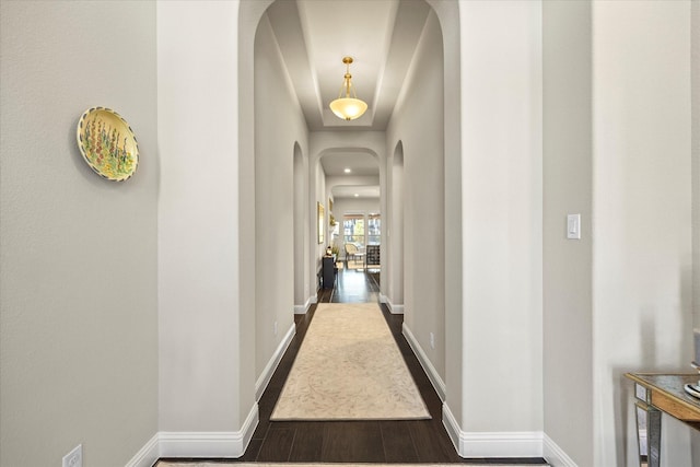 hallway with dark hardwood / wood-style flooring