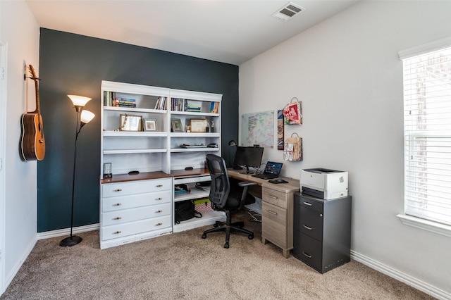 office space featuring plenty of natural light and light colored carpet