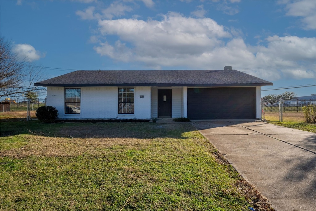 single story home featuring a front yard and a garage