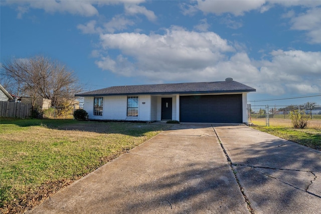 ranch-style house with a garage and a front lawn