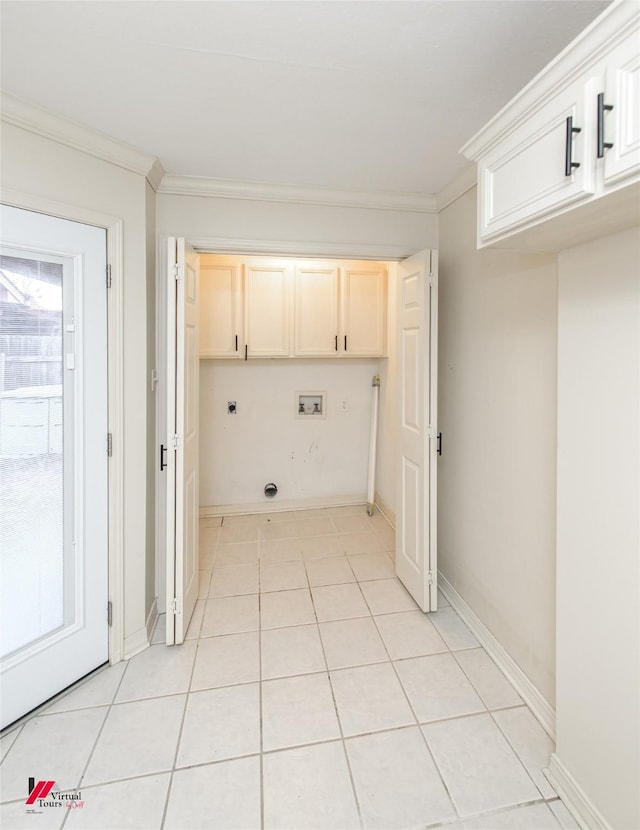 washroom with cabinets, crown molding, hookup for a washing machine, light tile patterned floors, and hookup for an electric dryer