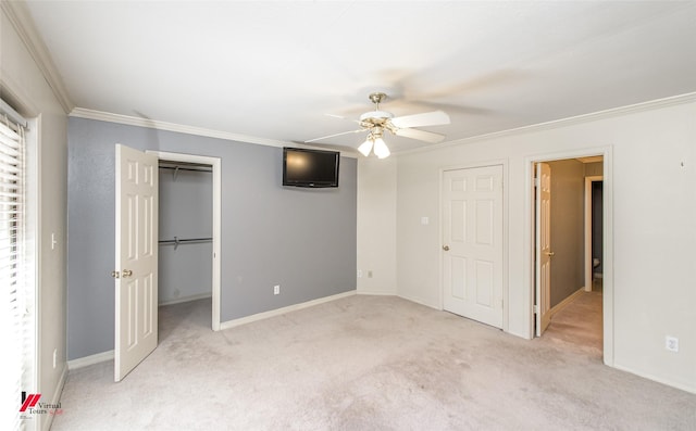 unfurnished bedroom with ceiling fan, light colored carpet, and crown molding