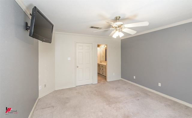 unfurnished bedroom featuring ceiling fan, ornamental molding, light carpet, and connected bathroom