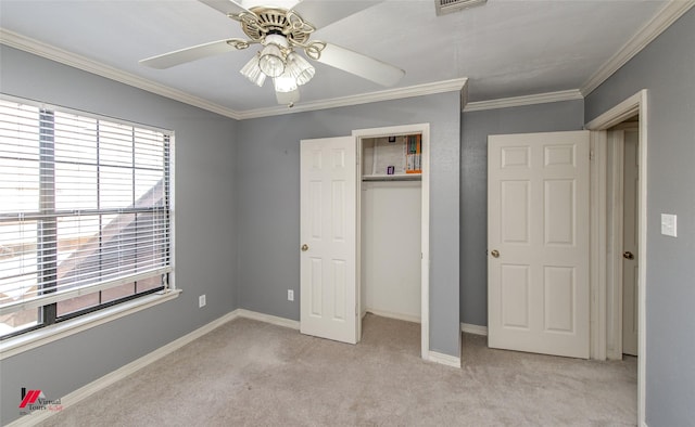 unfurnished bedroom with ceiling fan, a closet, light carpet, and ornamental molding